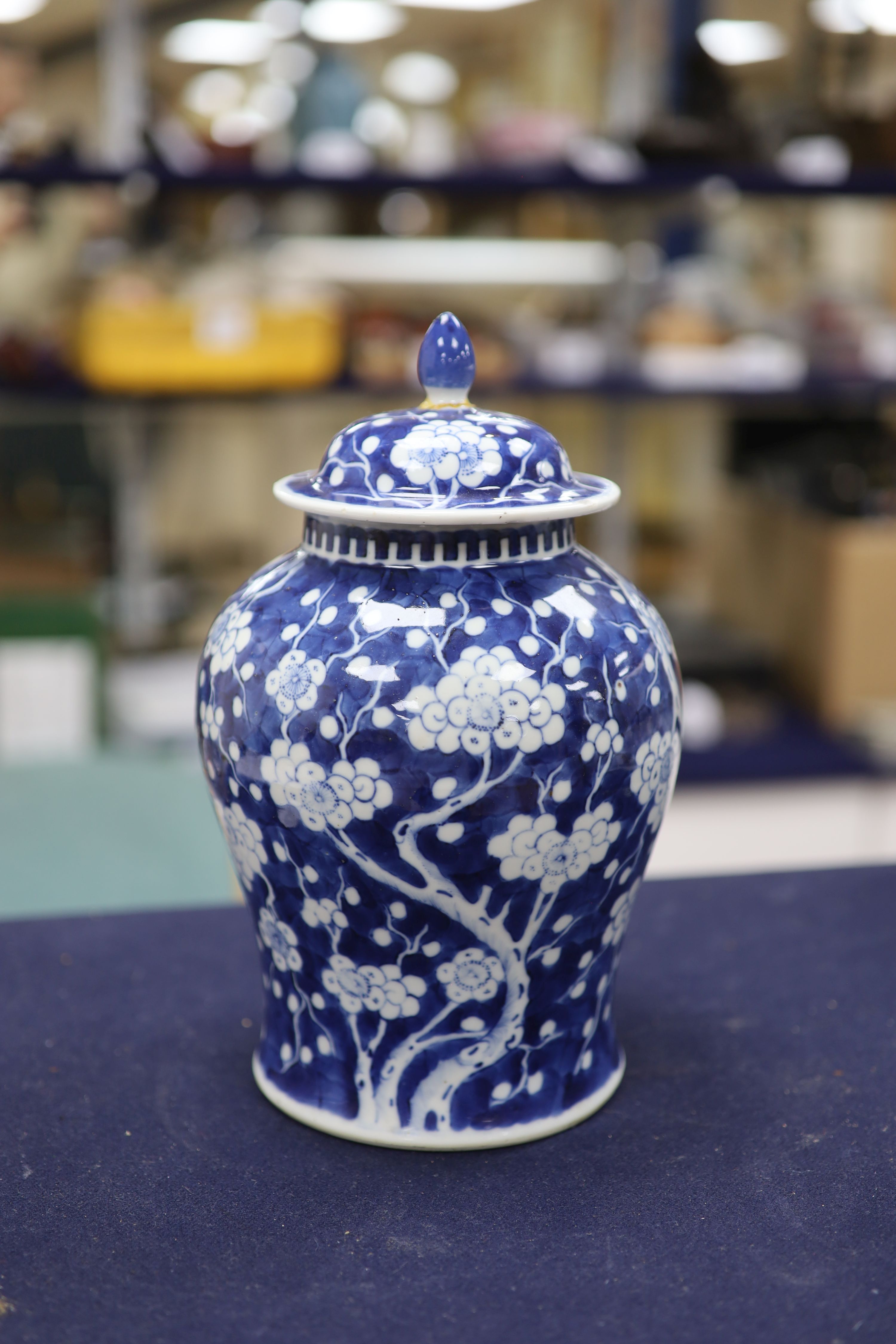 A 20th century Chinese blue and white jar and cover with prunus decoration, height 25cm